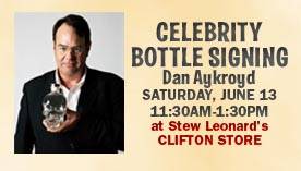 Dan Ackroyd signs his new brand of vodka.