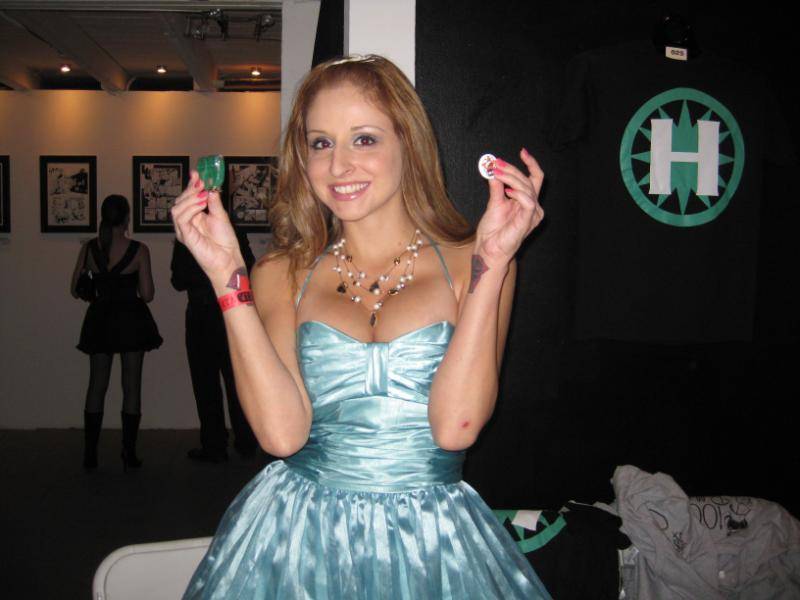 Hero volunteer Paris shows off pins and wristbands for sale.