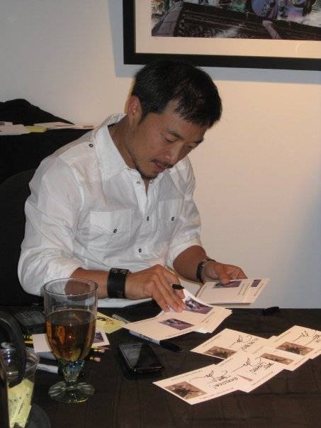 Jim Lee signing for people buying art from the gallery.