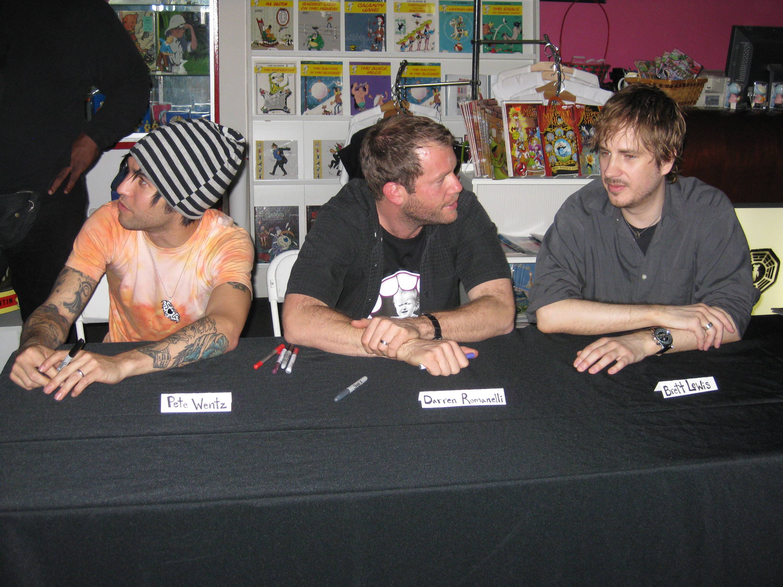 Pete Wentz, Darren Romanelli, and Brett Lewis sit down to prepare for the signing.