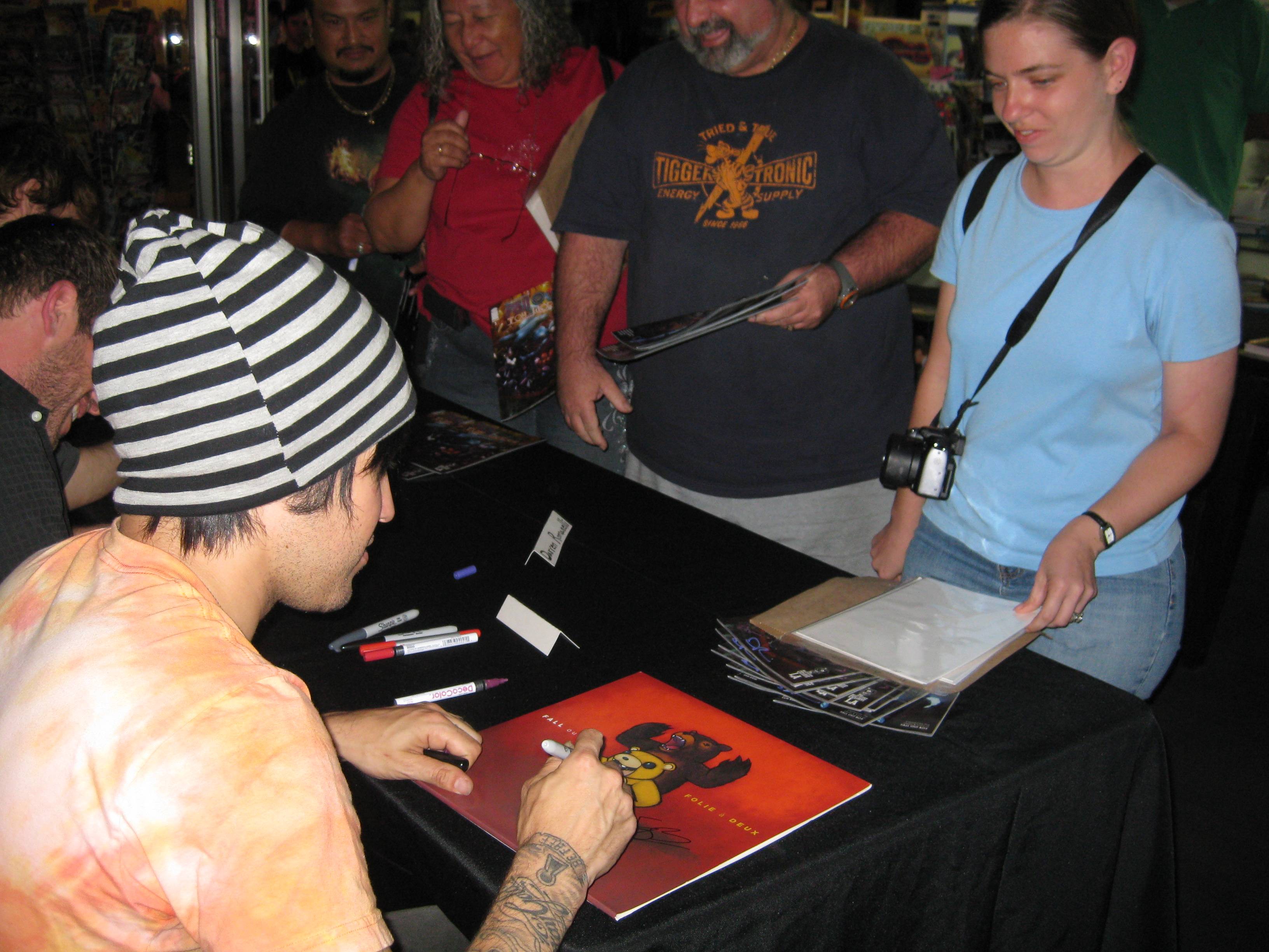 People brought various items, like album covers for Pete to sign.