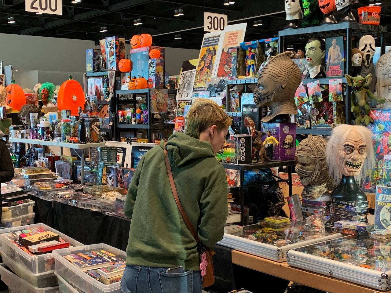 A group of people shopping at a collectibles convention.