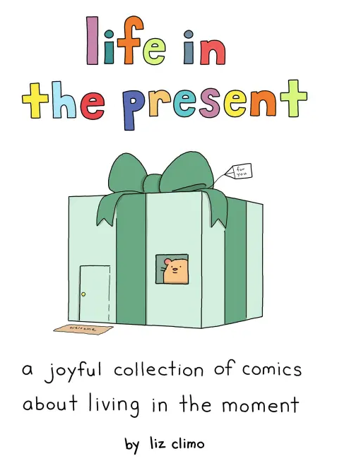 Illustrated book cover titled "Life in the Present" with a large green gift box featuring a small bear looking out from a window. Subtitle reads "a joyful collection of comics about living in the moment by Liz Climo.