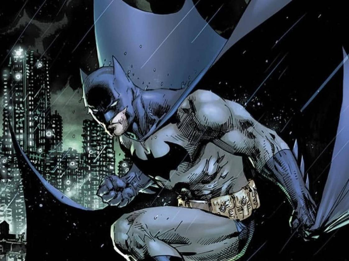 Illustration of Batman crouching on a rooftop in the rain, wearing his iconic cape, with a city skyline in the background.