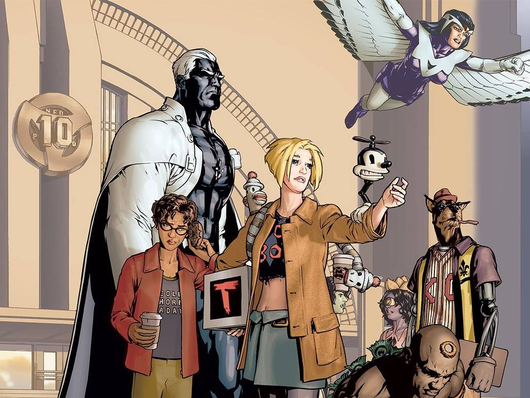 A group of diverse superheroes and characters stand together in front of a modern building; one woman points forward while another character flies above with wings.
