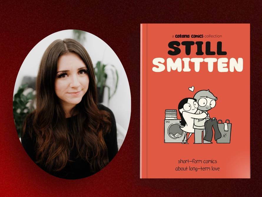 A woman with long dark hair sits next to the cover of the book "Still Smitten: Short-form comics about long-term love" by Catana Comics, featuring a cartoon couple hugging.